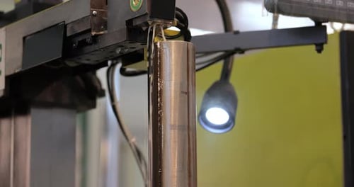 Metal Cylinder being Cut by Machine with Water