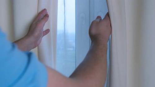 Hands Pulling Cream Curtain To Reveal Daytime Window