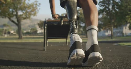 Low section view man with prosthetic leg stretching