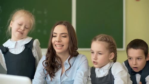 Teacher Explains Lesson to Eager Elementary Students