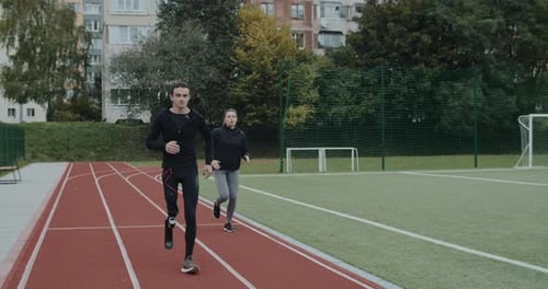 Man with Prosthetic Leg Running with Woman