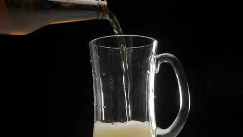 Golden Beer Pouring into Glass Mug