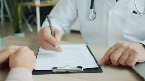 Medic Ticking Symptoms in Patient's Medical Records During Appointment in Clinic