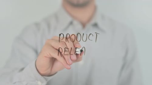 Product Release Writing on Screen with Hand