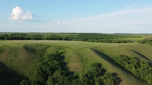 Tall Green Hills, Aerial View, White Cloud on the Blue Sky in the Background