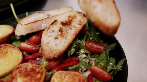 Serving piece of grilled bread on tomato salad, close up
