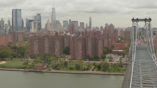 AERIAL: Flight Over Williamsburg Bridge Manhattan Side with New York City Skyline at Cloudy Day