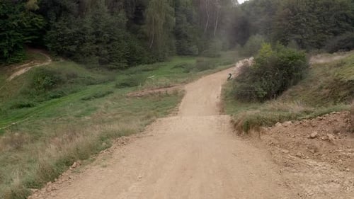 Racer On Sports Motorcycle Rides At High Speed On Dirt Road