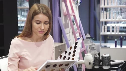 Woman Choosing Hair Color Samples at Salon
