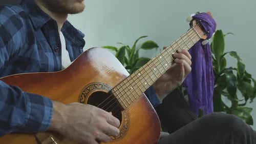 Man Playing Acoustic Guitar Indoors