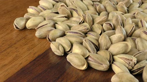 Pistachios in Shells on Wooden Table