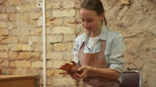 Female Potter Hands Working with Clay in Workshop