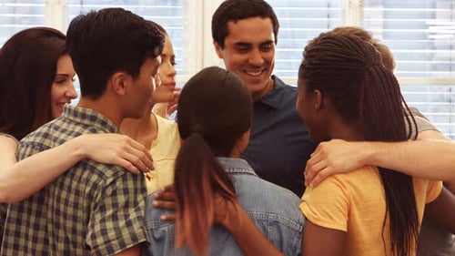 Diverse Young Adults Embracing in Circle Together