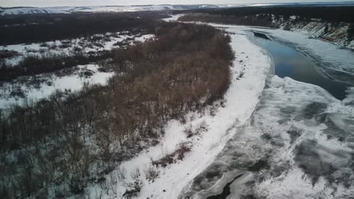 Calm Frozen River Covered with Ice on Cold Winter Day