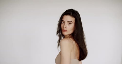 Elegant Woman Poses Confidently in a Studio Setting