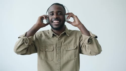 Man Enjoys Music While Wearing Headphones and Dancing