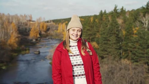 Woman Smiling by River in Autumn Nature