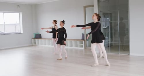 Four Women Dancing Ballet in Bright Studio