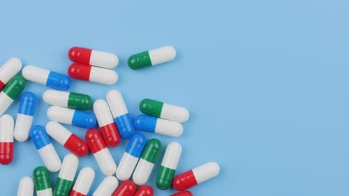 Colorful Medical Capsules on a Blue Background