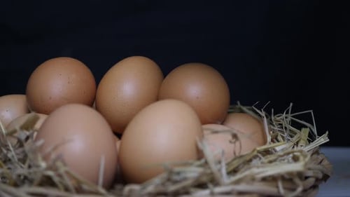 The cook reaches out to the chicken eggs.