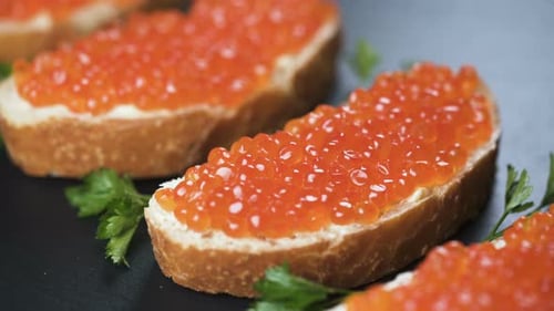 Caviar Sandwiches on a Dark Surface