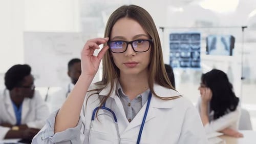 Smiling Young Doctor in White Coat Poses Confidently