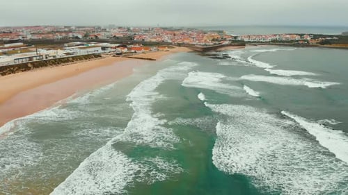Aerial View of Sea Waves Break on Yellow Sand Beach Peniche, Portugal