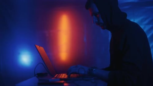 Hacker is Working on Laptop at Night
