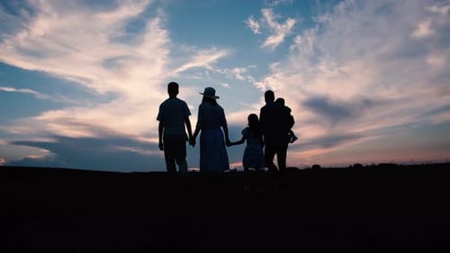 Family Walking Together at Sunset Silhouette