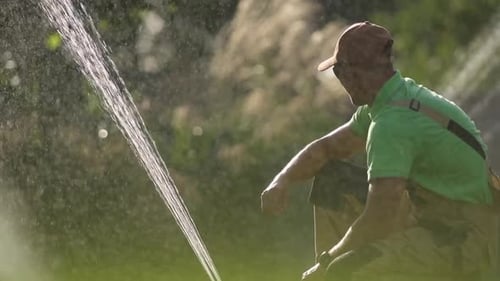 Garden Watering Systems. Technician Testing Watering Sprinkler System