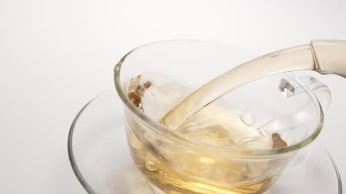 Pouring Tea into a Clear Glass Teacup
