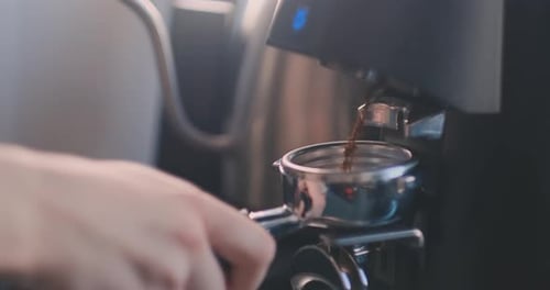 Grinding Fresh Coffee into Portafilter in Kitchen
