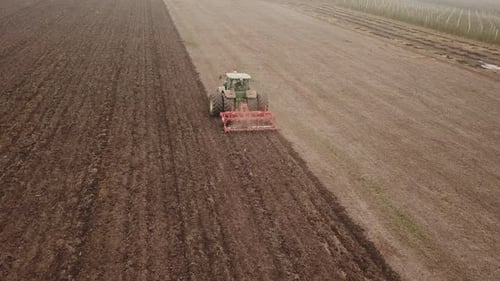 Tractor Plows a Field, Aerial View
