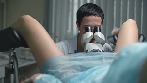 Gynecologist Examining Patient with Microscope in Clinic