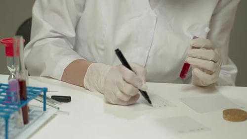 Person Labeling Blood Samples in Medical Lab