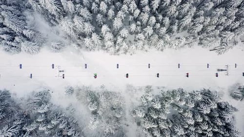 Snow mountain winter forest with chair lift at ski resort.