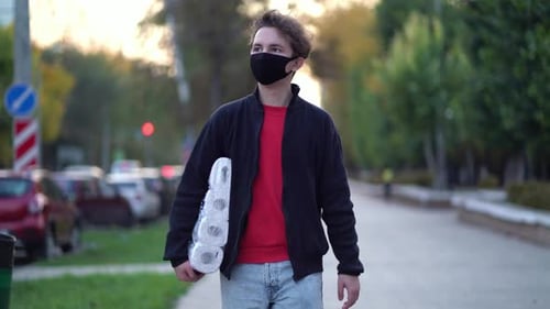 Young Man Walks with Toilet Paper, Wearing Mask