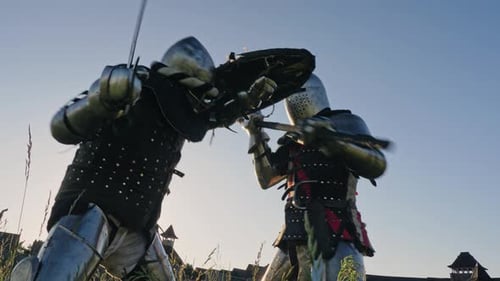 Armored Warriors Duel With Swords in Rural Setting