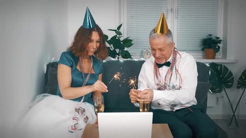 Couple Celebrates with Sparklers and Champagne at Home