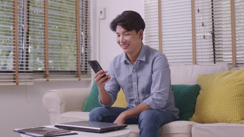 Man Looks at Phone, Happy With News