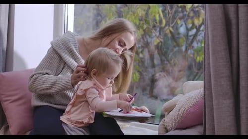 Loving Mother and Child Drawing Together Indoors