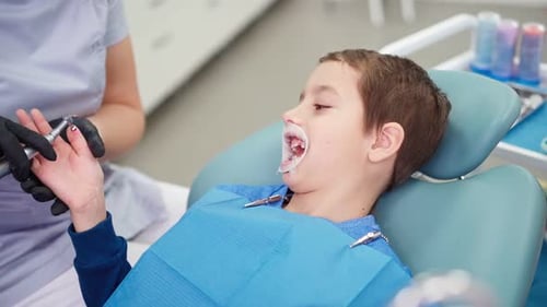Doctor in Dental Clinic Talking with Funny Little Boy Work Dentist with Children