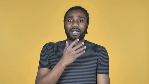 Man reacts in shock with hand to mouth