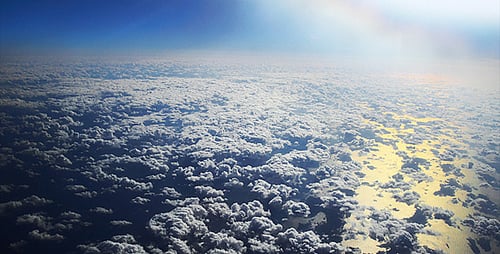 Aerial View of Clouds and Ocean on Bright Day
