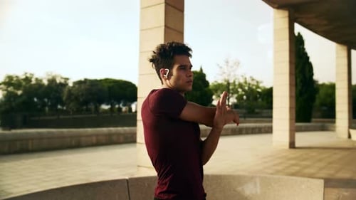 Young Adult Man Stretching Before Workout Outdoors