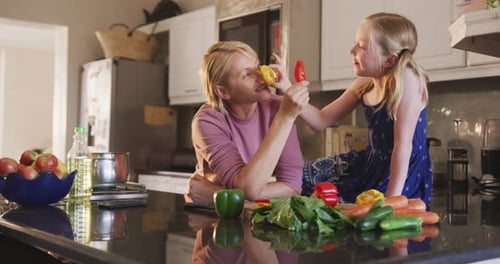 Side view of Caucasian woman cooking with her daughter at home