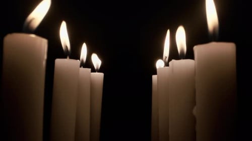 Burning Candle Against Black Background