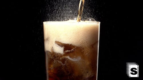 Iced Soda Being Poured into a Clear Glass
