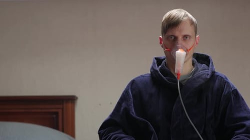 Man Napping In Oxygen Mask