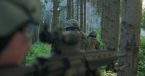 Millitary Operation with Gorup of Soliders Attacking Enemy Line in Dense Forest During Day Time